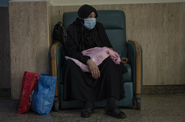 A woman waits with her baby at the Karantina Public Hospital Paediatric Emergency Department.  Following political collapse and the pandemic, the Lebanese economy plunged, wiping out 90% of people's s...