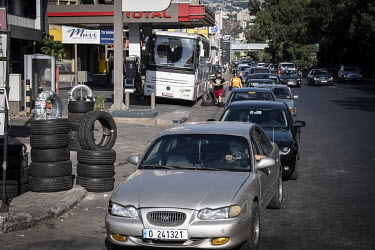 Cars form a long queue for petrol.  Following political collapse and the pandemic, the Lebanese economy plunged, wiping out 90% of people's savings and resulting in massive inflation. The ammonium nit...