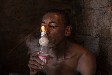 Matteo Rodrigues (35) smoking crack cocaine in a crack den in the neighbourhood of Ponta De Agua, Praia.  The Cape Verde islands lie on what's known as 'Highway 10', the DEA's nickname for the smuggli...