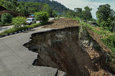 A macadam (asphalt) road which has collapsed due to a landslide.