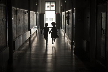 Children run along a corridor at the Dar Al Aytam Al Islamiya orphanage.  Following political collapse and the pandemic, the Lebanese economy plunged, wiping out 90% of people's savings and resulting...