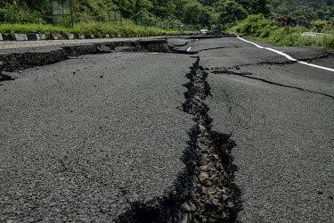 Cracks in a macadam (asphalt) road which was damaged by a landslide.