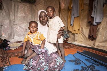 Amyra (30, not her real name) with her children at the Muna Garage IDP camp. She was abducted by Boko Haram, forced to marry and had a child, Ayan (three years old, right). Amyra escaped Boko Haram an...