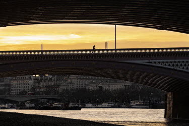 A runner crosses Blackfriars Bridge at sunset during the coronavirus lockdown.