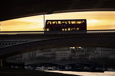A bus crosses Blackfriars Bridge at sunset during the coronavirus lockdown.