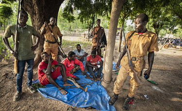 Four men, prisoners of a village self-defence force (Koglweogo or bush guardians), chained to a tree in the village of Poessin near Ouagadougou.  Once considered 'safe', Burkina Faso (meaning 'land of...