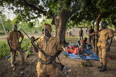 Four men, prisoners of a village self-defence force (Koglweogo or bush guardians), chained to a tree in the village of Poessin near Ouagadougou.  Once considered 'safe', Burkina Faso (meaning 'land of...