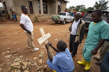 Staff write the details of the deceased on a cross as they bury Elodie Kitsama (19), who died from ebola the previous day at the Beni Ebola Treatment Centre. Elodie, who was still at school, died afte...