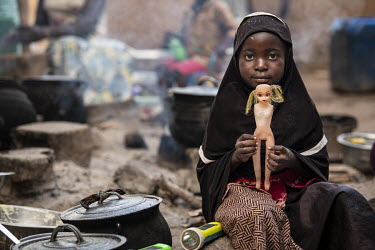 A girl plays with a doll with European features in an IDP camp on the outskirts of Ouagadougou.  Once considered 'safe', Burkina Faso (meaning 'land of the upright man') is suffering from increasing i...