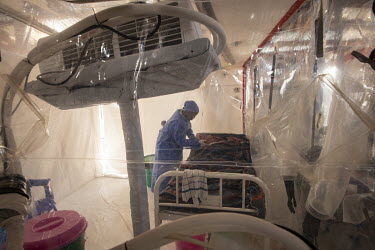 A six year old boy receives treatment in an isolation cube at the Butembo Ebola Treatment Centre.