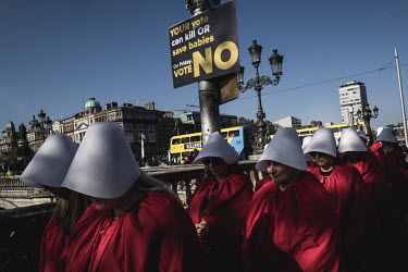 Pro-choice activists march past a sign errected by the anti-abortion lobby. Two days before the 2018 referendum on abortion was held in Ireland, a feminist group named Rosa organised an artistic perfo...