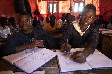 Ishara Vitswa (15) and Sylvain Vitswa (17) study in a class of students learning to be mechanics. They are able to study with the help of UNICEF grants. Five of their siblings and their mother died fr...