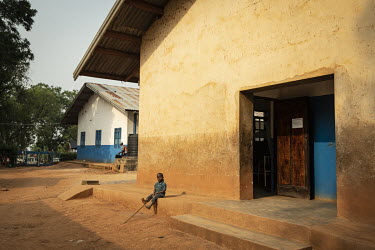 A boy sits outside a building at the MSF/UNICEF hospital.  There are at least 5.5 million internally displaced people (IDPs) in the DRC, mostly in the eastern provinces. In Ituri province alone there...