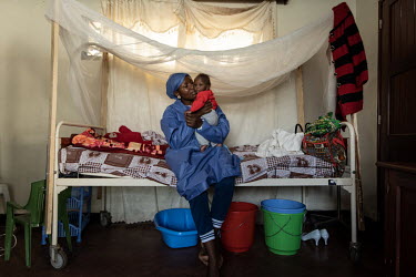 Ebola survivor Esperance looking after five-month old baby boy, Bosco (not real name). Masinda's husband was among the very first victims of the Ebola outbreak in July 2018 and she became ill in Augus...