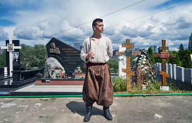 A Cossack stands on guard while waiting for the funeral procession of the commander of Carpathian Sich Battalion, Oleh Kutsin, at Baikove Cemetery.