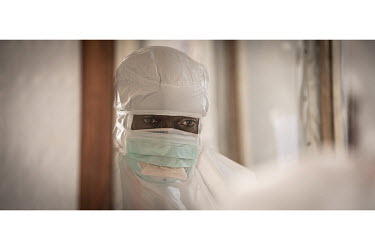 Hygienist Bertrand Karumba (33) prepares his personal protective equipment as he gets ready to enter the Ebola treatment centre's treatment area.  An Ebola outbreak was declared on 7 February 2021 in...