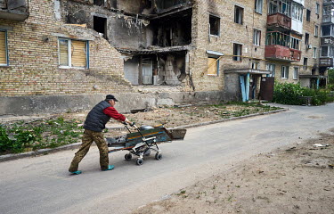 Valeriy clearing debris around the apartment blocks in Horenka. Horenka is a small village on the outskirts of Kyiv, which was shelled by Russian forces during the attack on Kyiv.