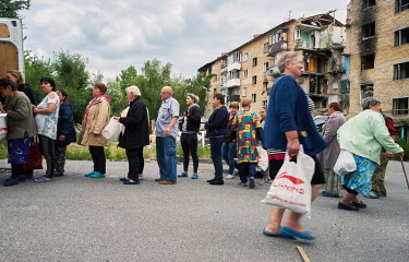 People waiting in a queue for food aid from the All Ukrainian Charitable Fund.
