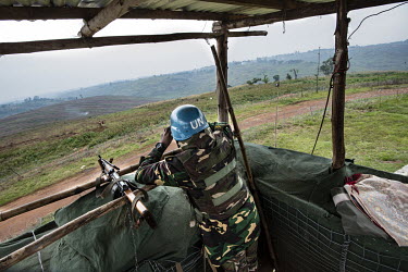 Lance Corporal Maidul, a MONUSCO (United Nations Organization Stabilization Mission in the Democratic Republic of the Congo) peacekeeper from Bangladesh looks through a pair of binoculars from his sec...