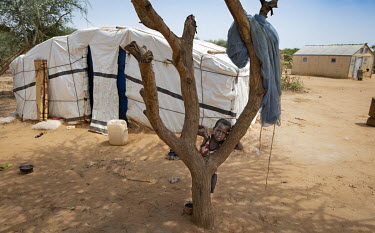 A child outside a shelter at the Lauda IDP camp on the outskirts of Ouagadougou. 195 people from Dablo Village, 90 km from Kaya, have fled fighting between government forces and Islamist insurgents fo...