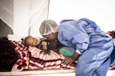 Nurse Docille Kimbes with Rosina (4 months) in the UNICEF creche at the Ebola Treatment Centre in Butembo. Her mother is in seriously unwell with Ebola although Rosina has not tested positive for the...