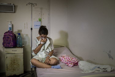 Rosa Esther (13) after she just gave birth to a daughter in San Miguel's hospital. Rosa was brutally raped in her village by a man related to gang members. He lives close to her school which resulted...