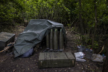 155mm shells for a Howitzer M777 artillery piece stored in a wooded area near an Ukrainian military base.