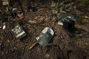 Discarded Russian military uniforms, ration packs and personal belongings near the scene of a failed pontoon bridge crossing. Earlier in May 2022, Ukrainian forces had inflicted heavy losses on a Russ...
