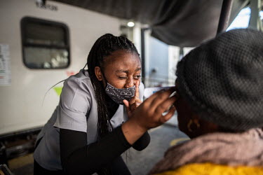 Eddnice, an optometry student working for the Phelophepa healthcare train, carries out an eye test during a visit to the town of Kroonstad. The train has 37 permanent staff but also relies on a rotati...