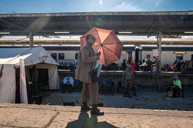 Corrections officer Sesi Motsoaleli watches over a group of prisoners who have been brought to the Phelophepa healthcare train during a stop in Kroonstad for various medical procedures and checks. The...