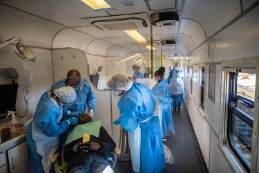 Dentists treat a patient in the dental carriage of the Phelophepa healthcare train during a stop at Kroonstad. The train has been providing primary health services to remote and under-resourced areas...