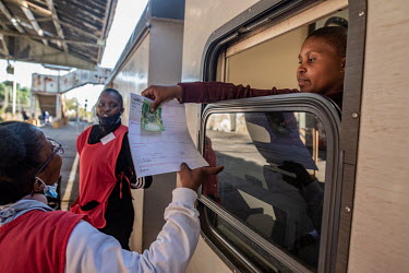 A pharmacist on the Phelophepa healthcare train takes payment for a patient's prescription. The train, whch is considerably more affordable than mainstram health facilities, has been providing primary...
