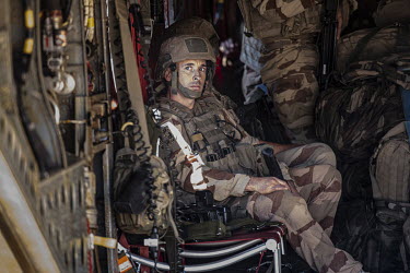 A French soldier in the back of an RAF Chinook after operations. The Chinook is deployed as part of Operation NEWCOMBE CH47, the codename for British military assistance to France's Operation Barkhane...