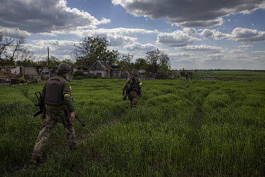 Ukrainian soldiers, from Zaporizhzhia territorial defence force, patrol the recently recaptured village of Novopil.