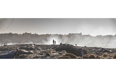 A boy scavenging on a rubbish dumps at an IDP camp.   Thousands of Fulani (semi-nomadic herders of the Sahel) have been displaced by fighting with the Dogon people and have fled to refugee camps in Ba...