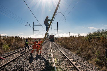 A maintenance team repairs damage to a railway line caused by cable thieves near Kroonstad. South Africa's railways have been hit hard by looting and vandalism in recent years, a problem that has grow...