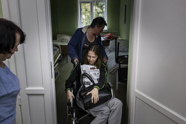 Maria Alefirenko (31),Â�who was injured in a mortar attack during the war in eastern Ukraine in 2014, arrives at a hospital in Sloviansk where evacuees were to stay overnight before being sent furthe...