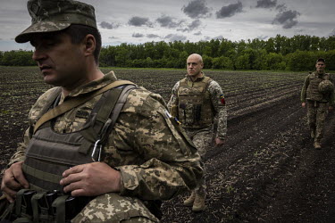 Colonel Roman Kachur, Commander of the 55th Separate Artillery Brigade of Ukraine's Armed Forces, walks towards a firing position.