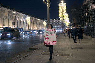 A woman takes part in a 'single picket' anti-war protest in the centre of Moscow: Her sign reads: 'Save the human in yourself, do not be silent.'