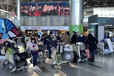 A queue in the departures hall at a Moscow airport. In the aftermath of Russia's invasion of Ukraine many Russian citizens fled overseas and as a result tickets for flights to the few remaining countr...