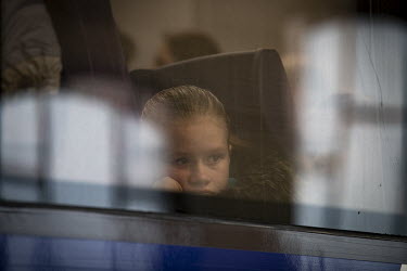 A child refugee looks out of train carriage window at Lviv Central railway station.