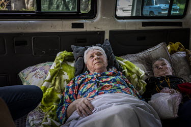 Zinaida (77), who is blind and struggled to walk, rests in a minibus after being carried from her apartment during an evacuation mission in the city of Bakhmut. As Russian forces continue their offens...