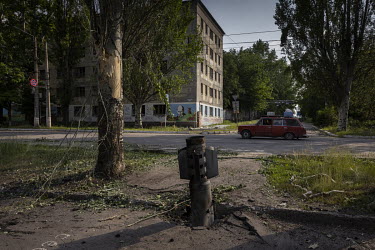 An unexploded Russian rocket protrudes out of the pavement in the city of Lysychansk.