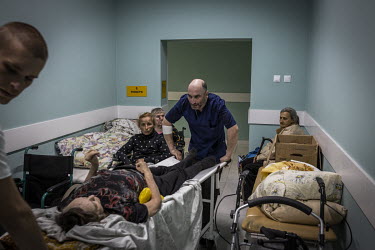 Evacuees arrive at a hospital in Sloviansk where they were to stay overnight before being sent further west by train. As Russian forces continue their offensive in eastern Ukraine, a range of mostly v...