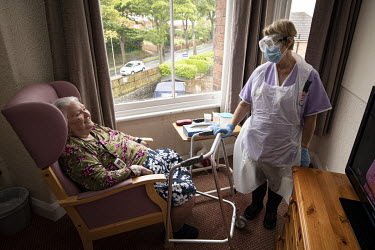 Denise Watson, Health Care Assistant at St Cecilia's Nursing Home with resident Lily (91) who has been 'discharged to assess' from hospital and is now on the COVID-19 isolation floor. The home has beg...