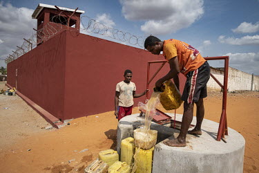 Inmates collect water from a new well at Ambovombe prison. Most rely on their families to deliver food, as a result many have died from malnutrition, at one stage at a rate of one per week.