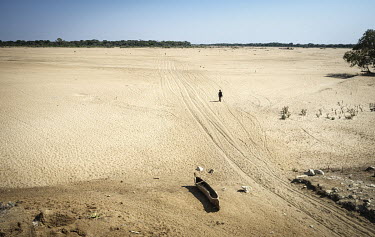 A man crosses the dry Menarandra River where average rainfall has fallen by nearly 50% in the past two years.