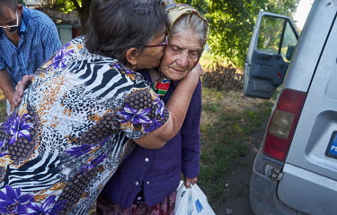 A daughter says goodbye to her mother, who is being evacuated from Pavlov to a safer place.