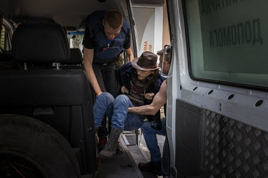Volunteers from the UK and Ukraine, working with the NGO Vostok-SOS, lift Oleksandr Samoilenko (44)Â�into a minivan during an evacuation mission in the city of Bakhmut. As Russian forces continue the...