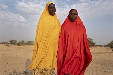 Nigerian refugee Kakahajja Abatcha (30, in red) takes a walk with her friend Hadiza Abakar (35). Many who have suffered at the hands of Boko Haram languish in the Dar es Salaam refugee camp, meaning '...